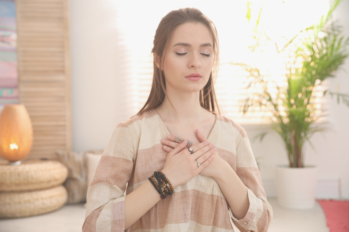 Girl deep breathing because of self-care for mental wellness